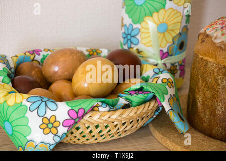 Table before Easter decorated with Easter cake, willow and eggs painted with onion peel Stock Photo