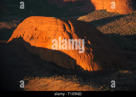 Aerial view of the domed rocks of Kata Tjuta in Australia's Northern Territory glowing in dawn sunlight. Stock Photo