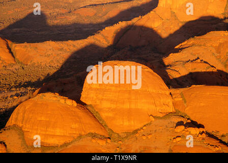Aerial view of the domed rocks of Kata Tjuta in Australia's Northern Territory glowing in dawn sunlight. Stock Photo