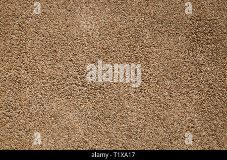 Wall with small gravel inserted into the plaster, forming a nice texture at Caceres. A charming town with a fully preserved old city center in Spain. Stock Photo