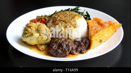 Nasi Padang - Padang Rice (with brain cow curry, beef rendang and omelet) Stock Photo