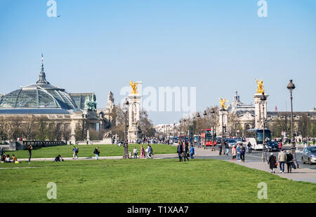 People walking ans resting on avenue des Invalides Grass - Paris, France Stock Photo