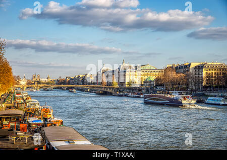 Boats traffic on Seine river with Orsay Museum in background - Paris, France Stock Photo