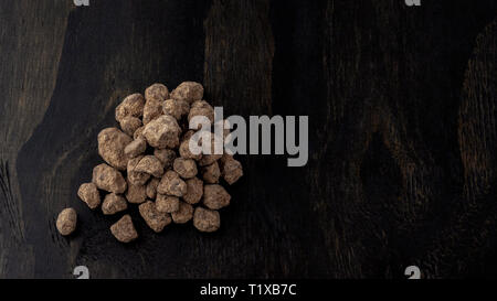 Organic Okinawan Japanese rock sugar close up on wood background Stock Photo