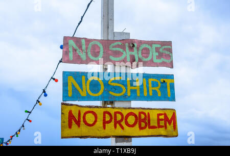 "No shoes, no shirt, no problem" sign on the beach Stock Photo