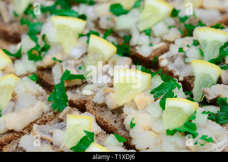 sandwiches with herring tartare on plate Stock Photo