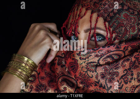 Scarf from Afghanistan around girl with beautiful green eyes Stock Photo