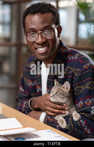 Man holding a cat in his hands Stock Photo