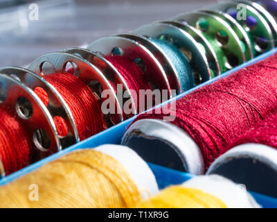 Close-up on bobbins of sewing threads. Sewing accessories. Stock Photo
