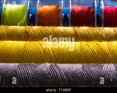 Macro Photography of sewing threads. The structure of the thread wound on a bobbin. Multicolored, vibrant colors. Stock Photo
