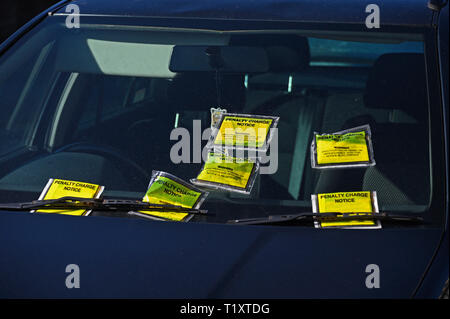 Windscreen of illegally parked car on double-yellow lines with six penalty charge notices. Parkside Road, Kendal, Cumbria, England, United Kingdom, Eu Stock Photo