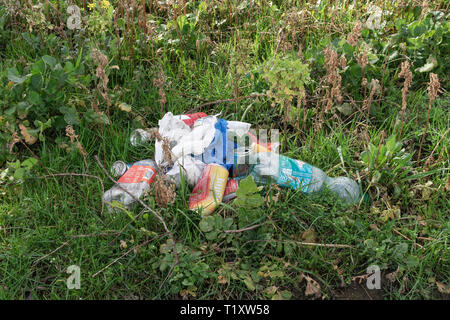 Sint Gillis Waas, Belgium - March 05, 2019, cans, plastic bottles and plastic bags dumped into the nature Stock Photo