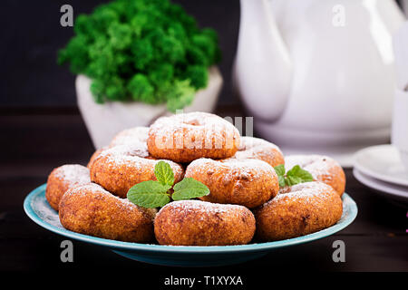 Brunch or lunch. Homemade donuts sprinkled with powdered sugar. Stock Photo
