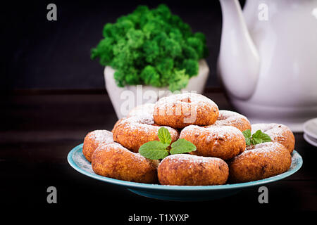 Brunch or lunch. Homemade donuts sprinkled with powdered sugar. Stock Photo
