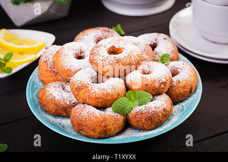 Brunch or lunch. Homemade donuts sprinkled with powdered sugar. Stock Photo