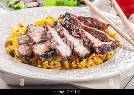 Char Siu Pork - Chinese roasted pork shoulder with fried rice on plate Stock Photo