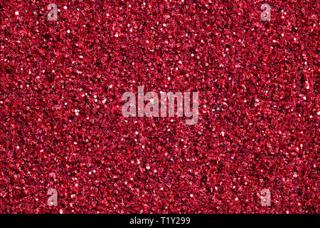 Bright crimson background with glitter. Red glitter texture. Stock Photo