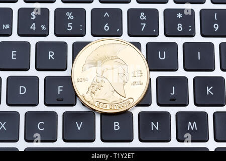 Cryptocurrency physical titan bitcoin coin on black computer keyboard. Stock Photo