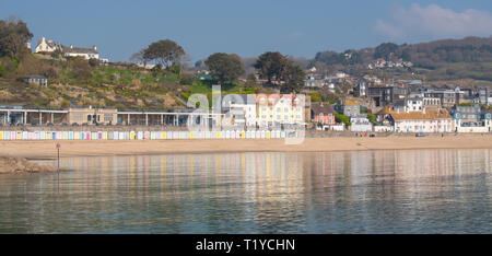Lyme Regis, Dorset, UK. 29th March 2019. UK Weather: Another day of glorious sunshine and bright blue skies as the seaside resort town of Lyme Regis as the early spring heatwave continues. The picturesque buildings are reflected in the calm water. Credit: Celia McMahon/Alamy Live News Stock Photo