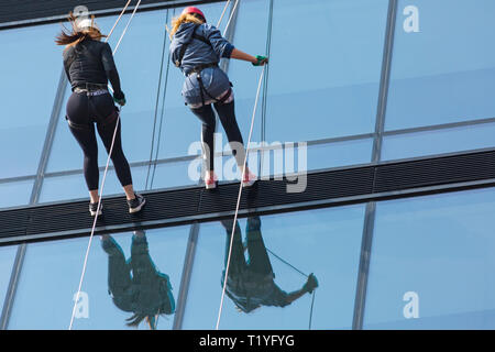Bournemouth, Dorset, UK. 29th Mar, 2019. Staff working for telecommunications provider 4Com abseil down their new office building at One Lansdowne Plaza in Bournemouth which is 100ft high. They are raising funds for Hope Housing and Hope AOK Rucksack Appeal who provide support to homeless in Bournemouth. A lovely warm sunny day for the descent! Two women abseil down. Credit: Carolyn Jenkins/Alamy Live News Stock Photo