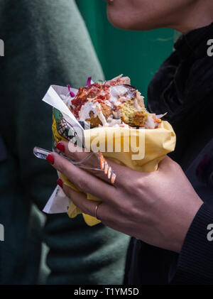 Eating falafel in the Marais area of Paris, France Stock Photo