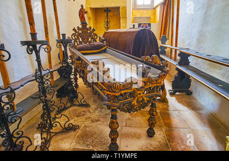 RABAT, MALTA - JUNE 16, 2018: Interior of the funeral room in Wignacourt Residence with preserved ritual furniture, richly decorated with carved patte Stock Photo