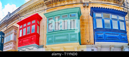 Panorama of colorful wooden Maltese balconies, decorating the facade of the edifice in old Rabat, Malta. Stock Photo