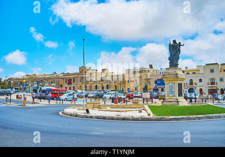 RABAT, MALTA - JUNE 16, 2018: The Museum square of Rabat is decorated with monument of St Joseph, surrounded by the small flower bed, on June 16 in Ra Stock Photo