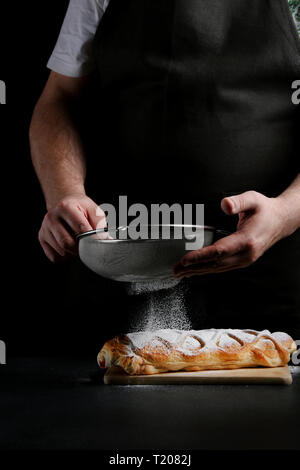 baker decorating on dark background. recipe concept. Stock Photo