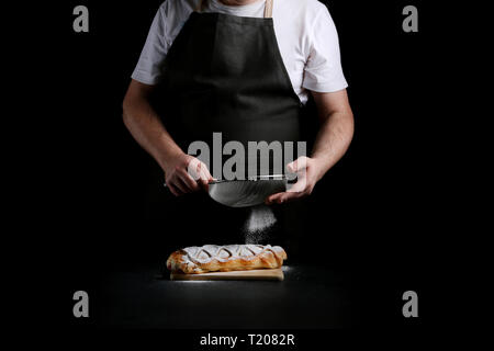 baker decorating on dark background. recipe concept. Stock Photo
