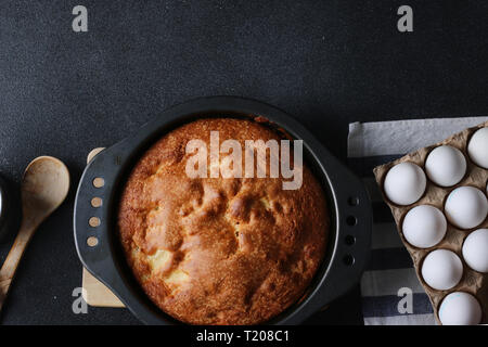 pie and ingredients for making on dark background top view. Stock Photo
