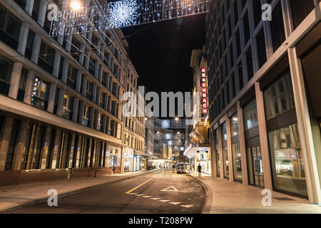 Geneva, Switzerland - November 24, 2016: Rue du Rhone. Night cityscape with illuminated facades in central area of Geneva city Stock Photo