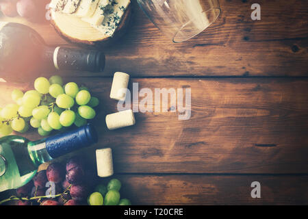 wine bottles grapes and cheese on wooden background. top view copyspace Stock Photo