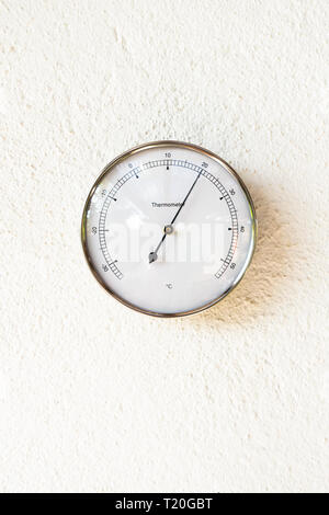 Large round analog thermometer hanging from bracket on outside wall Stock  Photo - Alamy