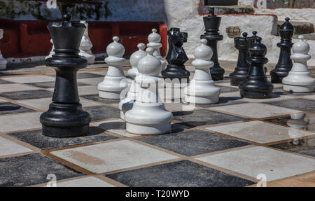 Greece, Kea island. Giant set of chess pieces on capital city of Ioulis street Stock Photo
