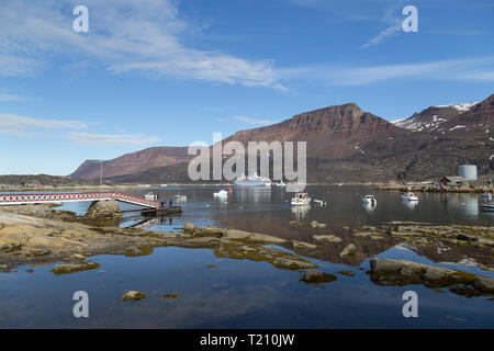 Ilulissat, Greenland - July 06, 2018: A big cruise ship and fishing boats anchored in Qeqertarsuaq harbor Stock Photo