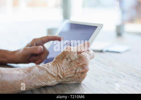 Woman's hand holding digital tablet, close-up Stock Photo
