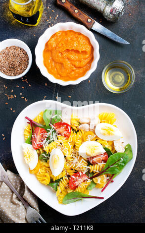 pasta with boiled eggs and cheese in bowl Stock Photo