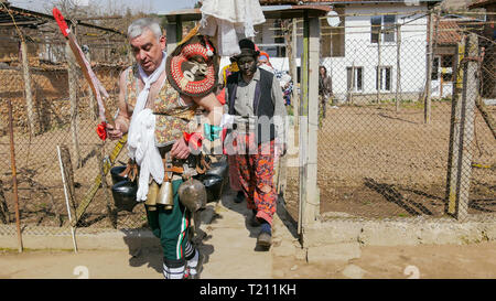 Turia, Bulgaria, 9 March 2019. Masquerade ritual Kukeri  to expel evil.  People from the village wear big bells and terrible costumes. Stock Photo