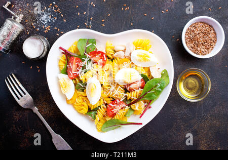 pasta with boiled eggs and cheese in bowl Stock Photo