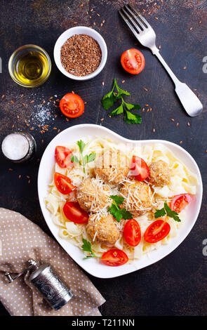 pasta with meatballs and fresh tomato in bowl Stock Photo