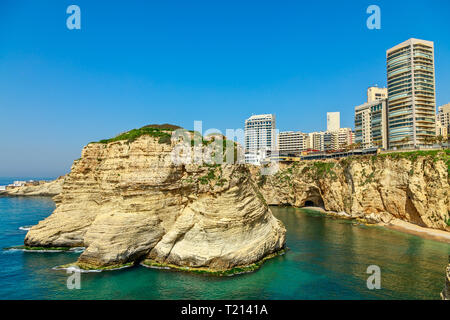 Raouche or pigeons rocks with sea and downtown buildings in the background, Beirut, Lebanon Stock Photo