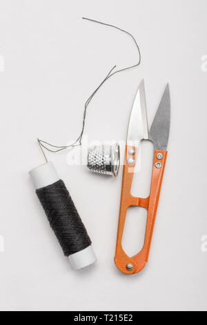 Black thread, thimble and scissors Stock Photo