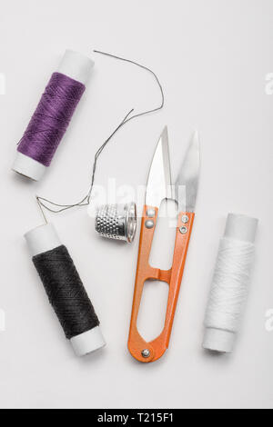 Thread, needle, thimble and scissors Stock Photo