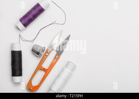 Thread, needle, thimble and scissors Stock Photo