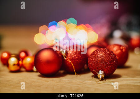 Red Christmas baubles on wooden floor, close-up Stock Photo