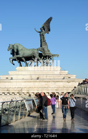 Tourists Enjoy Panoramic Views over the Rooftops of Rome from the Vittorio Emanuele II Monument with Winged Victory Sculpture Rome Italy Stock Photo