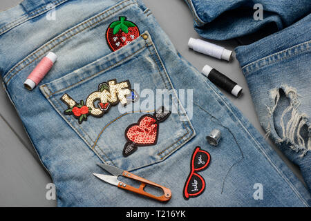 Applying patches to jeans Stock Photo