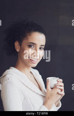 A young Afro Latin American woman taking her coffee break Stock Photo