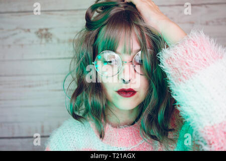 Portrait of beautiful woman wearing nose ring and glasses Stock Photo